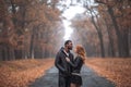 Interracial couple posing in autumn park road Royalty Free Stock Photo