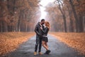 Interracial couple posing in autumn park road Royalty Free Stock Photo