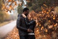 Interracial couple posing in blurry autumn park background