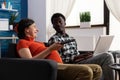 Interracial couple with pregnancy smiling and relaxing at home Royalty Free Stock Photo