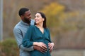 Pregnant wife in love looking at her husband in a park Royalty Free Stock Photo
