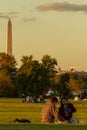 An interracial couple is sitting on a picnic blanket on Gravelly point park Royalty Free Stock Photo