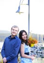 Interracial couple standing by boat pier Royalty Free Stock Photo