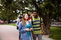 Interracial couple walking in park together with their friends Royalty Free Stock Photo
