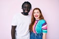 Interracial couple wearing casual clothes with a happy and cool smile on face Royalty Free Stock Photo
