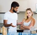 interracial family couple with serious faces quarrelling in kitchen