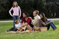 Interracial family of five having picnic in park Royalty Free Stock Photo