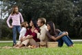 Interracial family of five having picnic in park Royalty Free Stock Photo