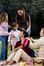 Interracial family of five having picnic in park Royalty Free Stock Photo