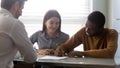 Interracial family make deal purchasing first dwelling signing contract Royalty Free Stock Photo