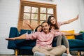 An interracial family shares a heartwarming moment at home playing plane games Royalty Free Stock Photo