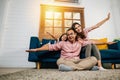 An interracial family shares a heartwarming moment at home playing plane games Royalty Free Stock Photo