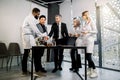 Interracial group of business men and doctors scientists team meeting in modern lab or office, standing at the table Royalty Free Stock Photo