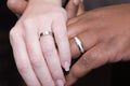 Interracial hands with wedding rings