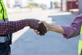 Interracial handshake. Handshake between African and a Caucasian man outdoor. Black and white hand shaking. Cooperation and people Royalty Free Stock Photo