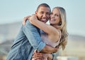 Interracial, happy couple and smile portrait hug of people in summer with happiness or love. Couple, outdoor and smiling