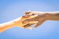 Interracial human hands crossing fingers for friendship and love Royalty Free Stock Photo