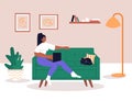 Interracial lesbian couple relaxing on comfy sofa in living room. Spending time together in apartment. Woman with laptop