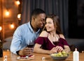 Interracial Love. Portrait Of Happy Multicultural Couple On Romantic Date In Restaurant