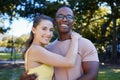 Interracial, portrait and couple hug, park or smile for relationship, romance or bonding. Love, black man or woman Royalty Free Stock Photo