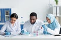 Interracial scientists working with test tubes Royalty Free Stock Photo