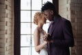 Interracial tender wedding couple. Young african american man and caucasian woman rehearse wedding dance. Mixed-race