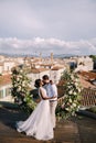 Interracial wedding couple. Destination fine-art wedding in Florence, Italy. A wedding ceremony on the roof of the Royalty Free Stock Photo