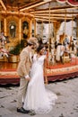 Interracial wedding couple. Wedding in Florence, Italy. African-American bride and Caucasian groom near the carousel.