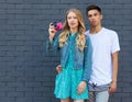 Interracial young couple in love outdoor. Stunning sensual outdoor portrait of young stylish fashion couple posing in summer. Girl Royalty Free Stock Photo