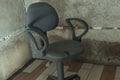 The interrogation chair. An old chair in a concrete basement.