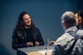 Interrogation of a homicidal maniac in the interrogation room. A police detective sits at a table with a suspect. Royalty Free Stock Photo