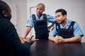 Interrogation, investigation and police team with a suspect for questions as law enforcement officers. Security, crime Royalty Free Stock Photo