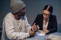 In the interrogation room, a suspect in a drug distribution and possession case consults with a public defender Royalty Free Stock Photo