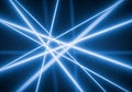 Intersecting blue neon beams create a dynamic pattern against a dark background. Th Royalty Free Stock Photo