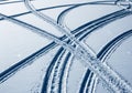 Intersecting tire tracks in smooth, white snow form a noticeable pattern Royalty Free Stock Photo