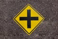 Intersection ahead sign on asphalt road texture background