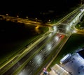 intersection at night from the drone wet road, road lighting wet road, road lighting cars road lanes