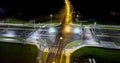 intersection at night from the drone wet road, road lighting