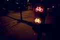 intersection at night with traffic light for a cycling lane showing red and yellow bicycle symbol in dark light mood Royalty Free Stock Photo