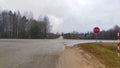 The intersection of paved roads with markings and sandy verges near the village. Signs are installed along the road, and various t Royalty Free Stock Photo