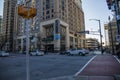 An intersection on Peachtree Street surrounded by hotels, office buildings, traffic signals and cars and trucks driving