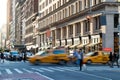 The intersection of 23rd Street and 5th Avenue is busy with taxis and people during the rush hour commute in New York City Royalty Free Stock Photo