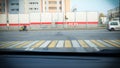 At the intersection of t-shaped cars are at a traffic light and wait for the green signal and on the road passing motorcycle