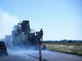 Road Crews Apply Asphalt to Blacktop a Highway