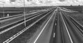 Interstate road in open countryside with blue car speeding up