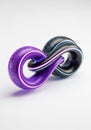Intertwined glossy toruses, one purple and the other black, create a visually striking Royalty Free Stock Photo