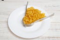 Interval eating, fasting, diet concept. Conditional image of the time of eating pasta and forks on a plate Royalty Free Stock Photo