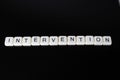 Intervention text word title caption label cover backdrop background. Alphabet letter toy blocks on black reflective background. W