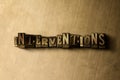 INTERVENTIONS - close-up of grungy vintage typeset word on metal backdrop Royalty Free Stock Photo