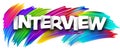 Interview paper word sign with colorful spectrum paint brush strokes over white